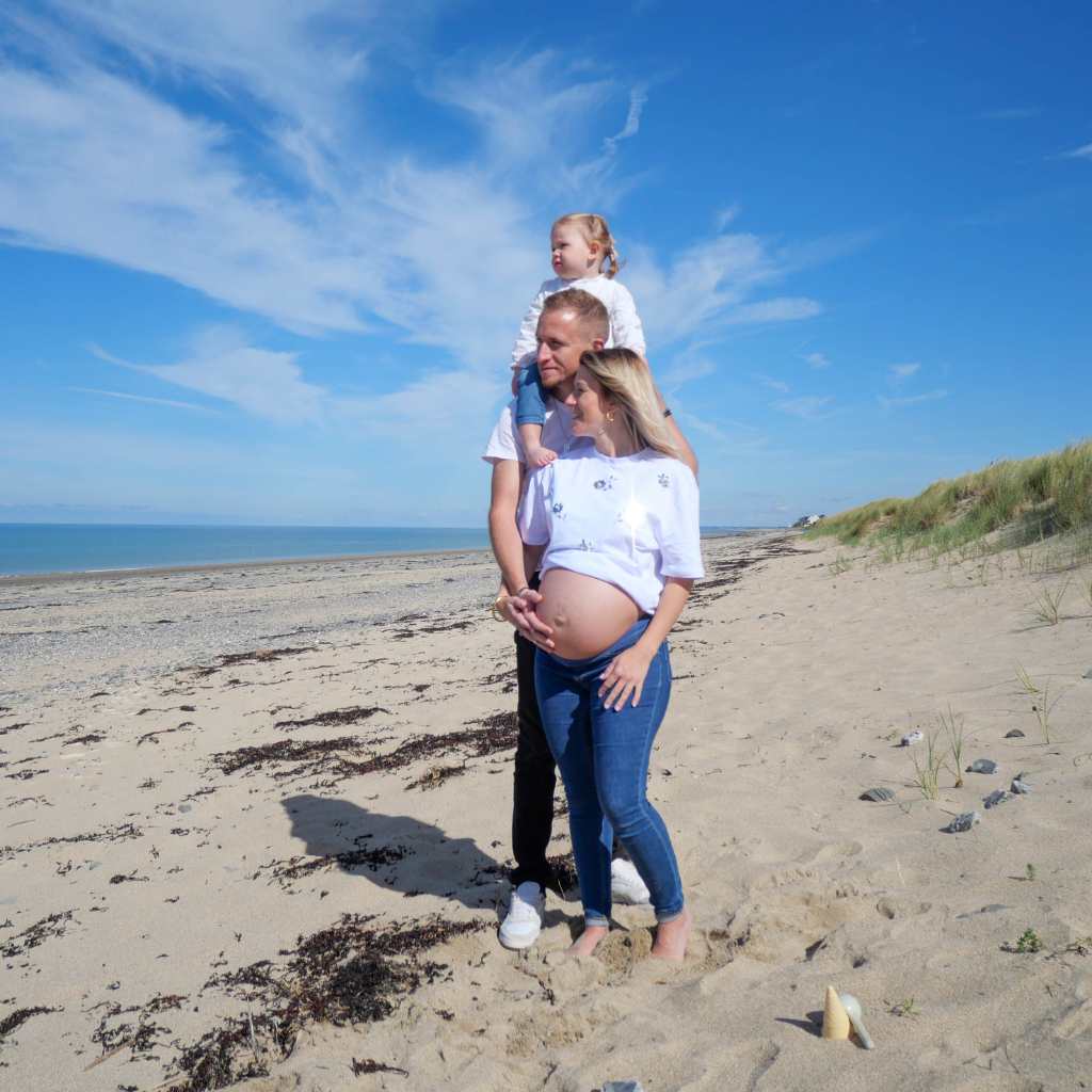 Séance grossesse en famille sur la plage, capturée en vidéo dans la Manche, moments précieux et émouvants.